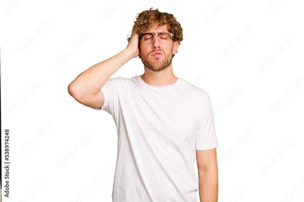 Naklejka premium Young caucasian man isolated on green chroma background tired and very sleepy keeping hand on head.