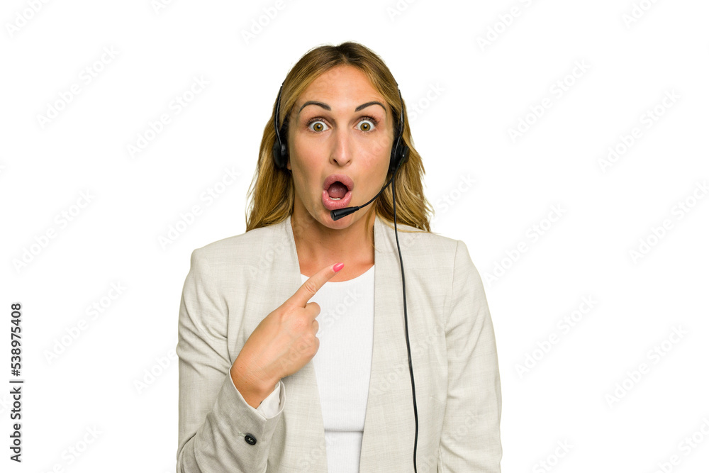 Telemarketer caucasian woman working with a headset isolated on green chroma background pointing to the side Telemarketer caucasian woman working with a headset isolated on green chroma background pointing to the side