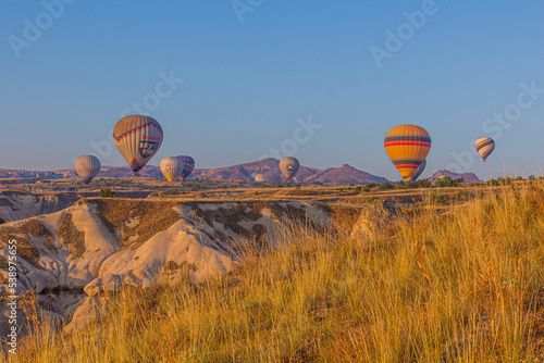 GOREME, TURKEY - JULY 20, 2019: Hot air balloons above Cappadocia, Turkey