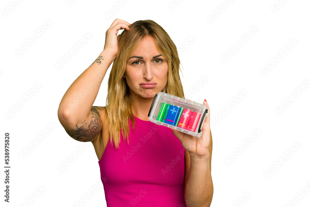 Young caucasian woman holding battery box isolated on green chroma background being shocked, she has remembered important meeting. Young caucasian woman holding battery box isolated on green chroma background being shocked, she has remembered important meeting.