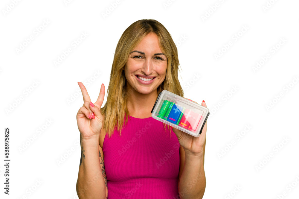 Young caucasian woman holding battery box isolated on green chroma background showing number two with fingers. Young caucasian woman holding battery box isolated on green chroma background showing number two with fingers.