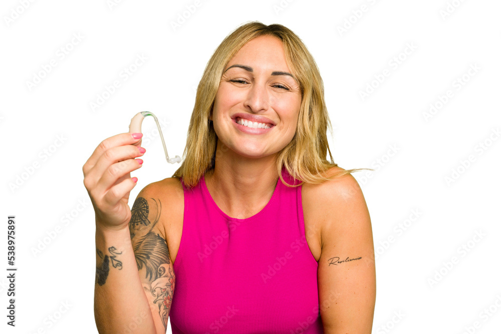 Young caucasian woman wearing hearing aid isolated on green chroma background laughing and having fun. Young caucasian woman wearing hearing aid isolated on green chroma background laughing and having fun.