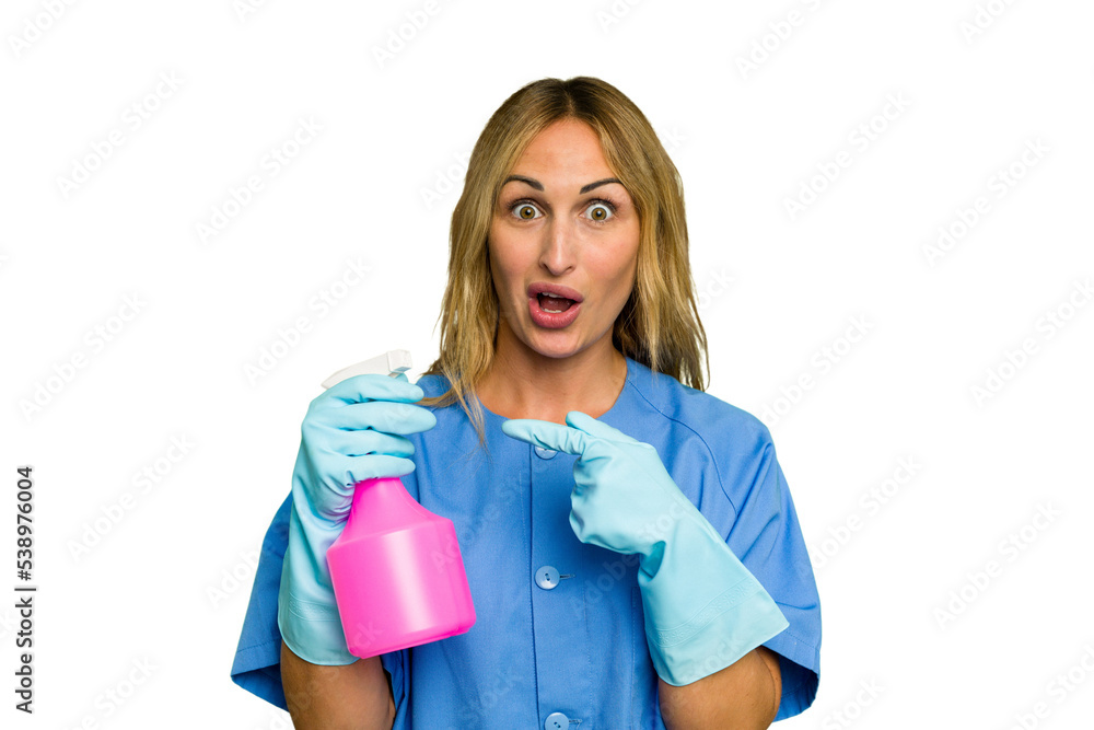 Young cleaner caucasian woman isolated green chroma background pointing to the side Young cleaner caucasian woman isolated green chroma background pointing to the side