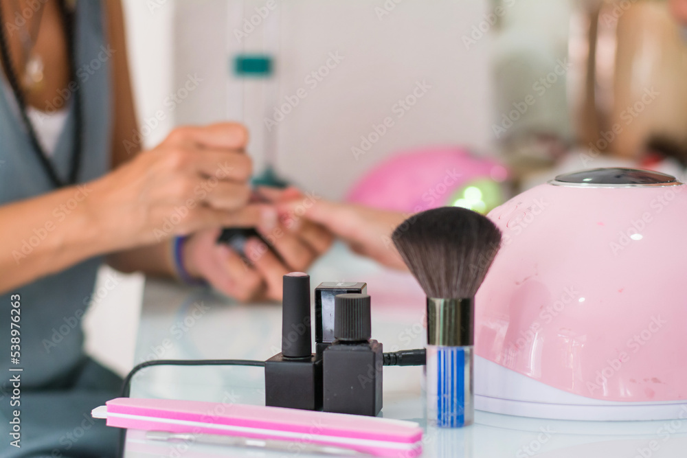 Tools For Manicure With Blurred Hands At Background In A Beauty Nail Salon