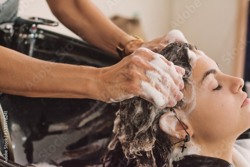 Young Woman Washing Hair In Salon.
Close-up of a woman washing her hair in a beauty salon by Hairdressing Salon. Lifestyle