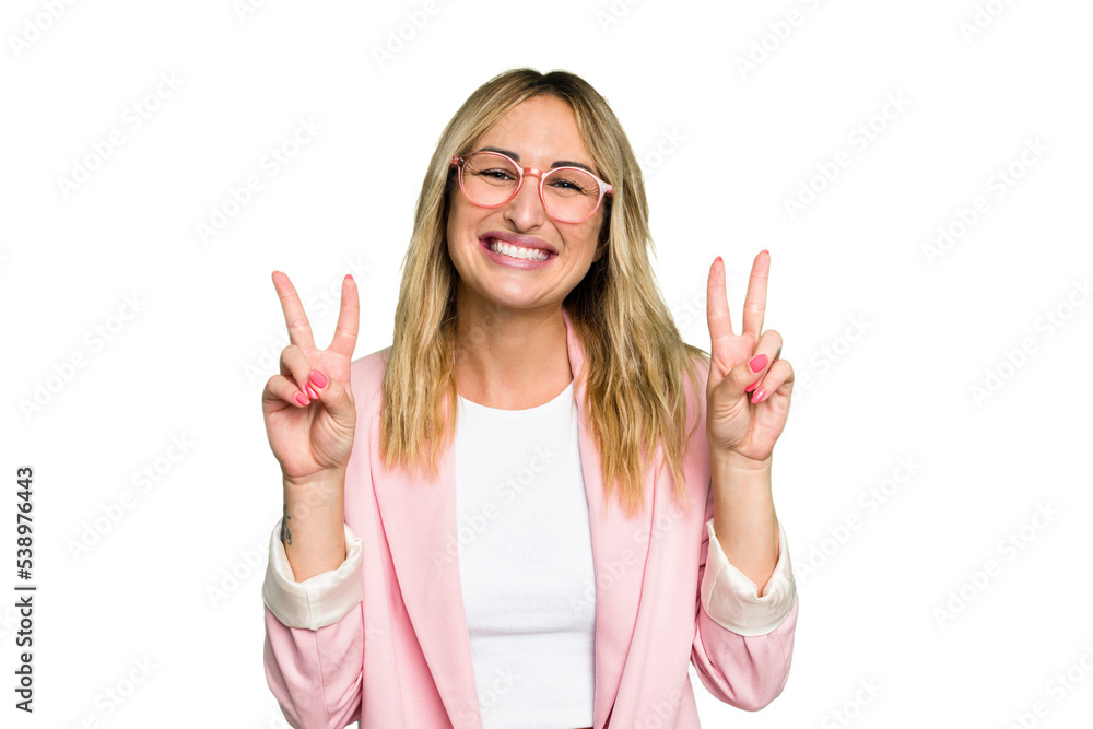 Young caucasian woman isolated on green chroma background showing victory sign and smiling broadly.