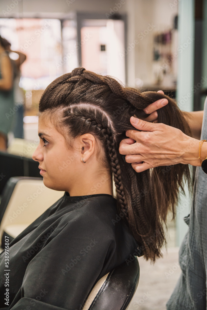 Naklejka premium Beautiful Woman Getting Haircut By Hairdresser In The Beauty Salon. Hair style concept