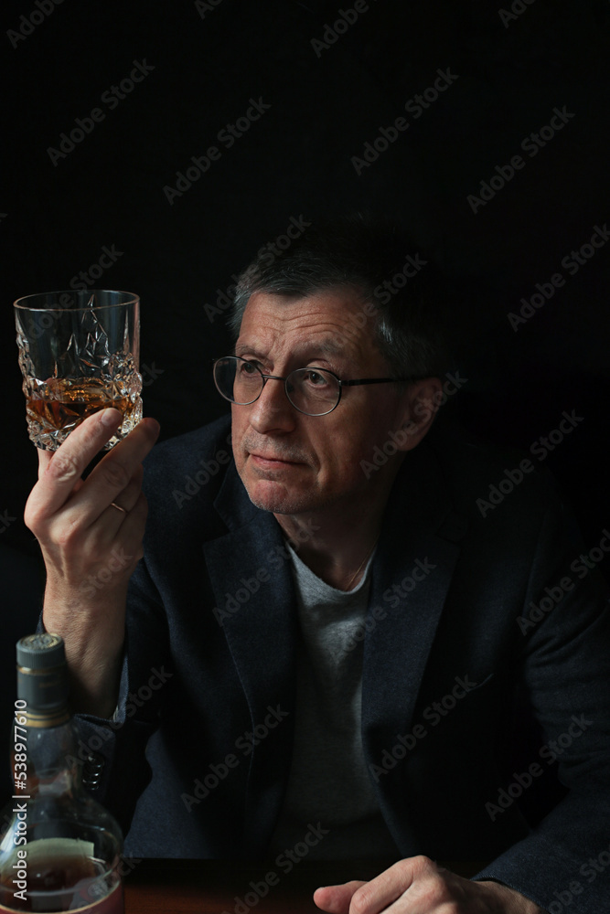person with glass of whiskey