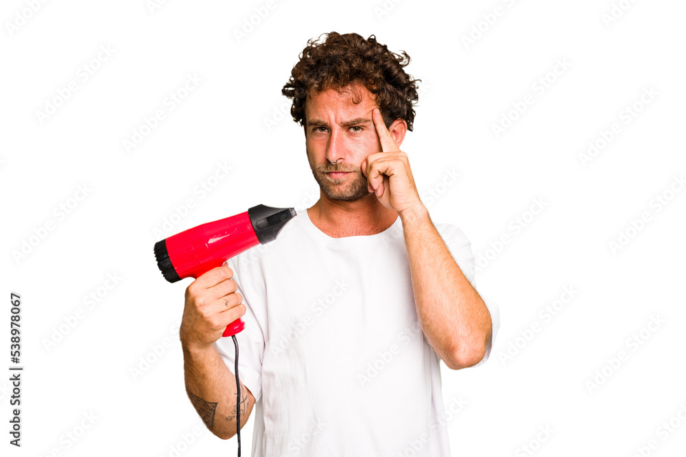 Young caucasian man holding an hairdryer isolated pointing temple with finger, thinking, focused on a task. Young caucasian man holding an hairdryer isolated pointing temple with finger, thinking, focused on a task.