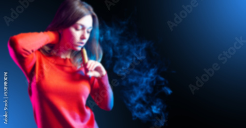 Woman smokes vape. Girl blo...