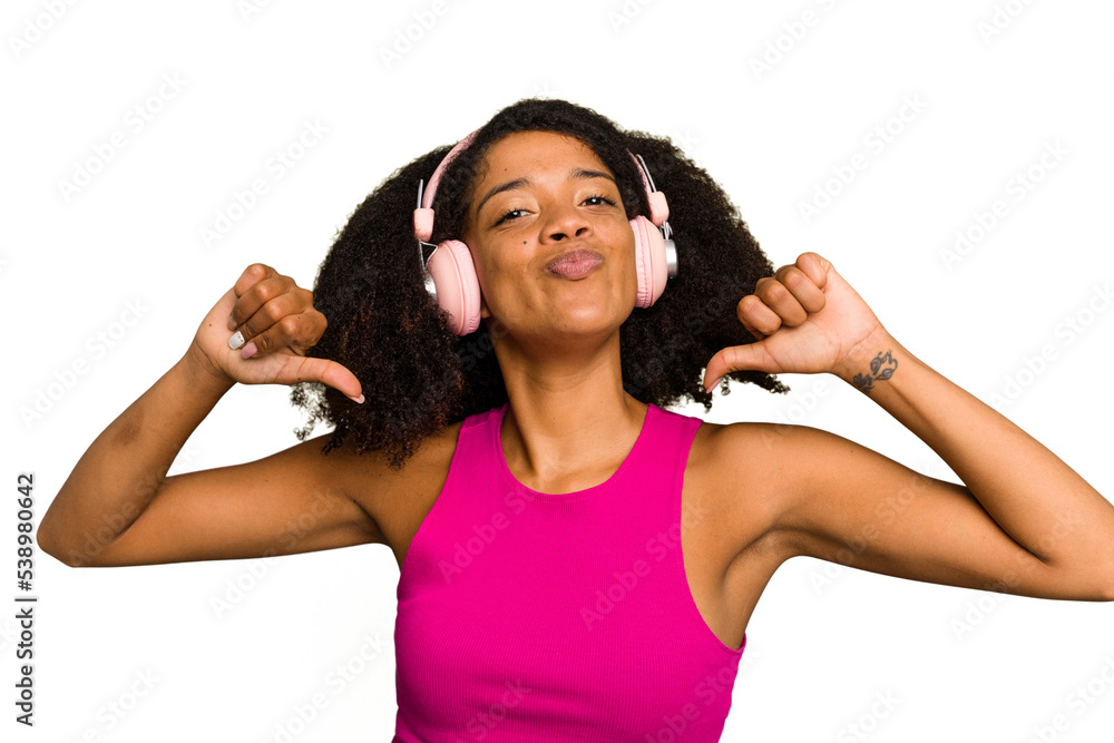 Young African American woman wearing headphones isolated feels proud and self confident, example to follow.