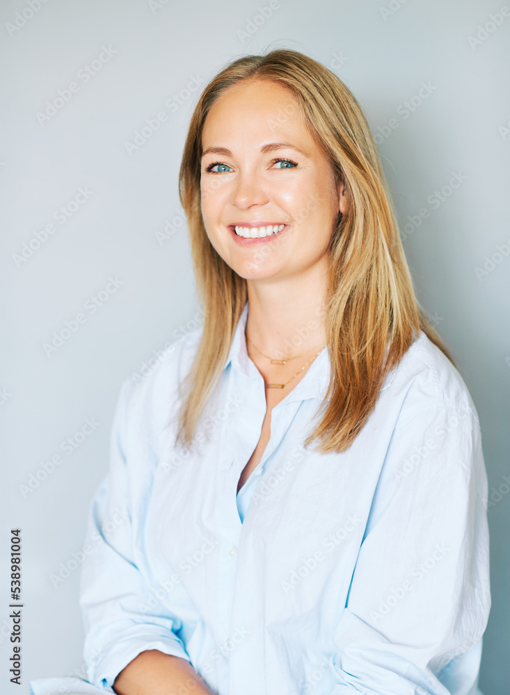 Studio portrait of beautiful young woman on blue background Studio portrait of beautiful young woman on blue background