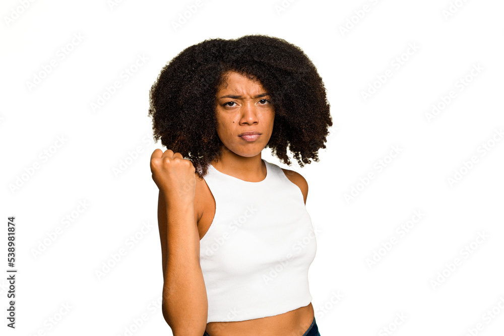 Young African American woman isolated showing fist to camera, aggressive facial expression. Young African American woman isolated showing fist to camera, aggressive facial expression.