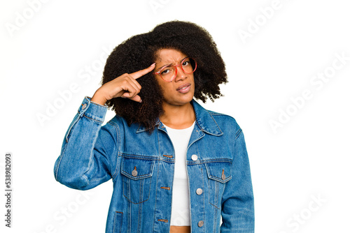 Young African American woman isolated pointing temple with finger, thinking, focused on a task.