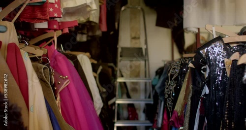Wallpaper Mural The movement of the camera through the rows of clothes in the store. Wooden hangers hold the items on the metal tube. Metallic staircase. Torontodigital.ca