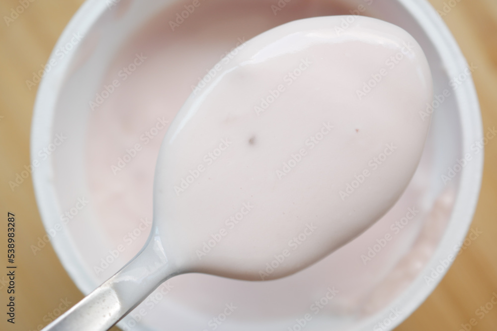 fresh yogurt on a spoon close up fresh yogurt on a spoon close up