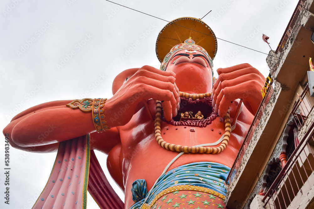 Big statue of Lord Hanuman near the delhi metro bridge situated near Karol Bagh, Delhi, India, Lord Hanuman big statue touching sky - obrazy, fototapety, plakaty 