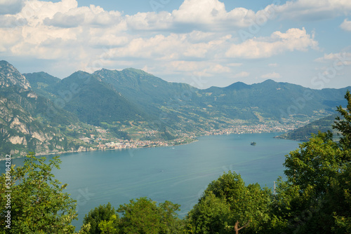 Panorama at Lake Iseo and mountains around at sunny day with clouds. Bergamo, Lombardy, Italy. © robertobinetti70
