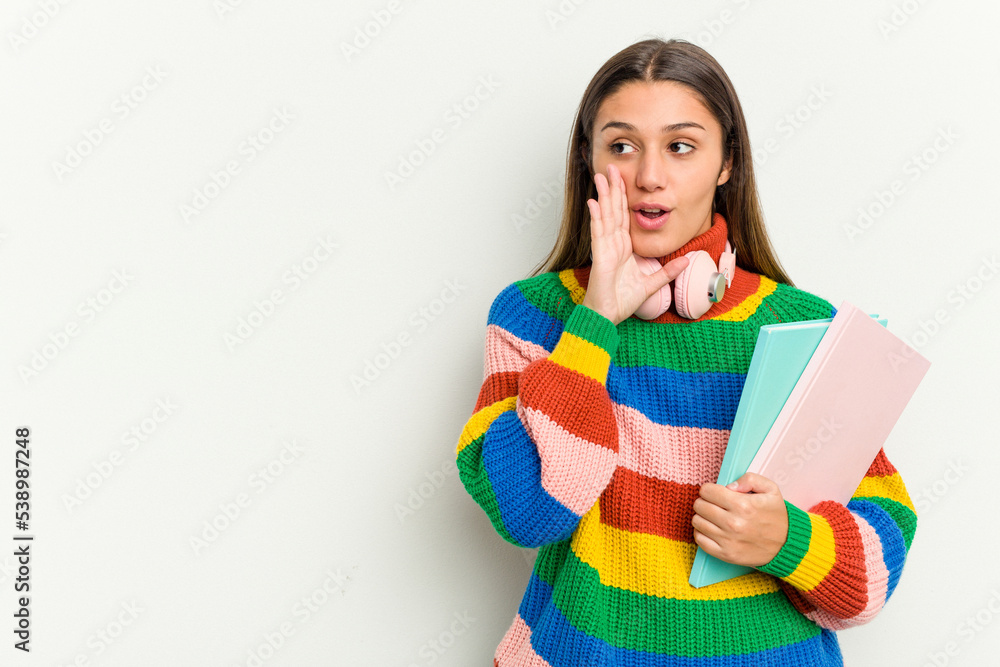 Young student Indian woman isolated on white background is saying a secret hot braking news and looking aside Young student Indian woman isolated on white background is saying a secret hot braking news and looking aside