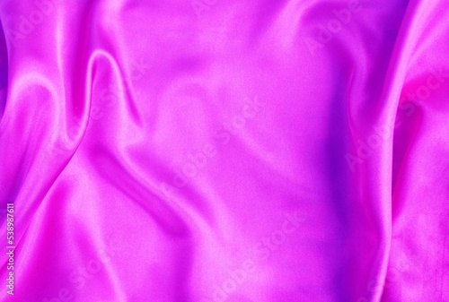 Beautiful bright pink fabric, folded in soft folds. Silk, satin or satin ribbon.