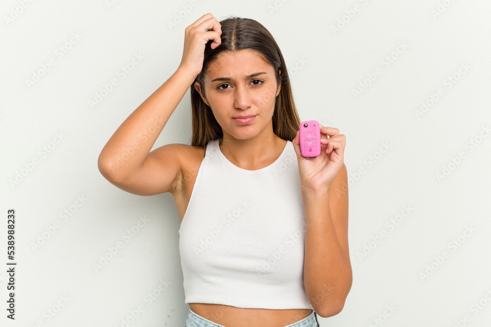 Young indian woman holding an electronic pink car keys being shocked, she has remembered important meeting. Young indian woman holding an electronic pink car keys being shocked, she has remembered important meeting.
