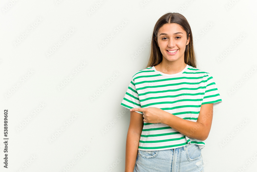 Young Indian woman isolated on white background smiling and pointing aside, showing something at blank space. Young Indian woman isolated on white background smiling and pointing aside, showing something at blank space.
