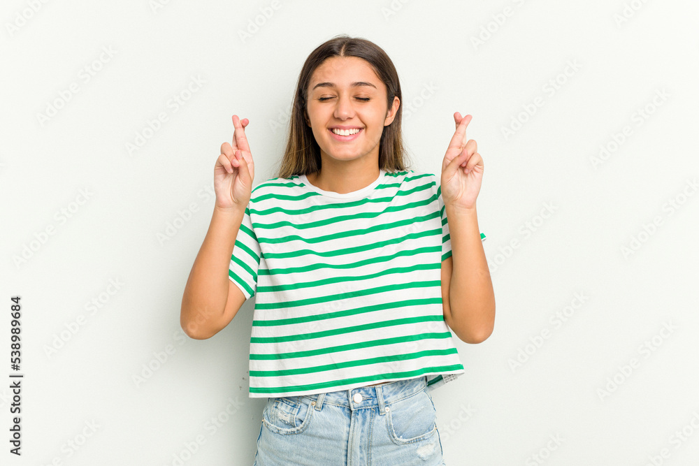 Young Indian woman isolated on white background crossing fingers for having luck Young Indian woman isolated on white background crossing fingers for having luck