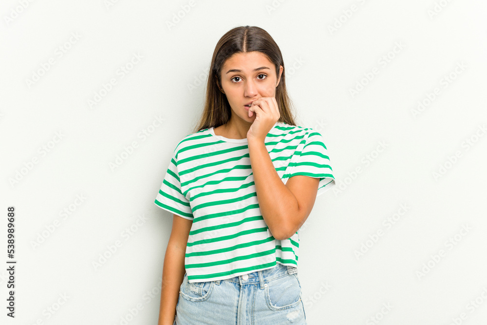 Young Indian woman isolated on white background biting fingernails, nervous and very anxious. Young Indian woman isolated on white background biting fingernails, nervous and very anxious.