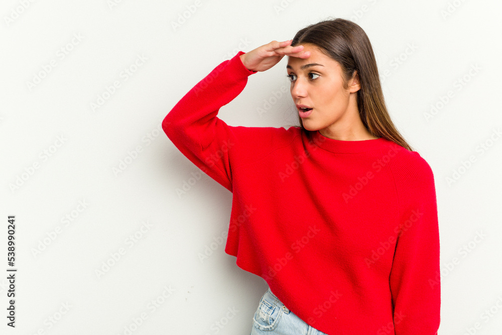 Young Indian woman isolated on white background looking far away keeping hand on forehead. Young Indian woman isolated on white background looking far away keeping hand on forehead.
