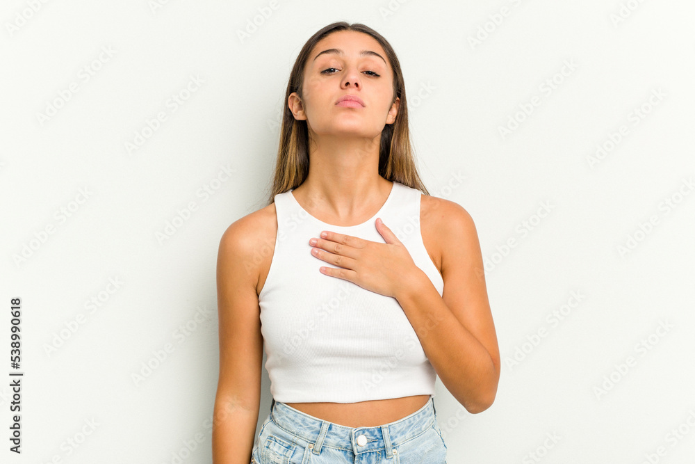 Young Indian woman isolated on white background taking an oath, putting hand on chest. Young Indian woman isolated on white background taking an oath, putting hand on chest.