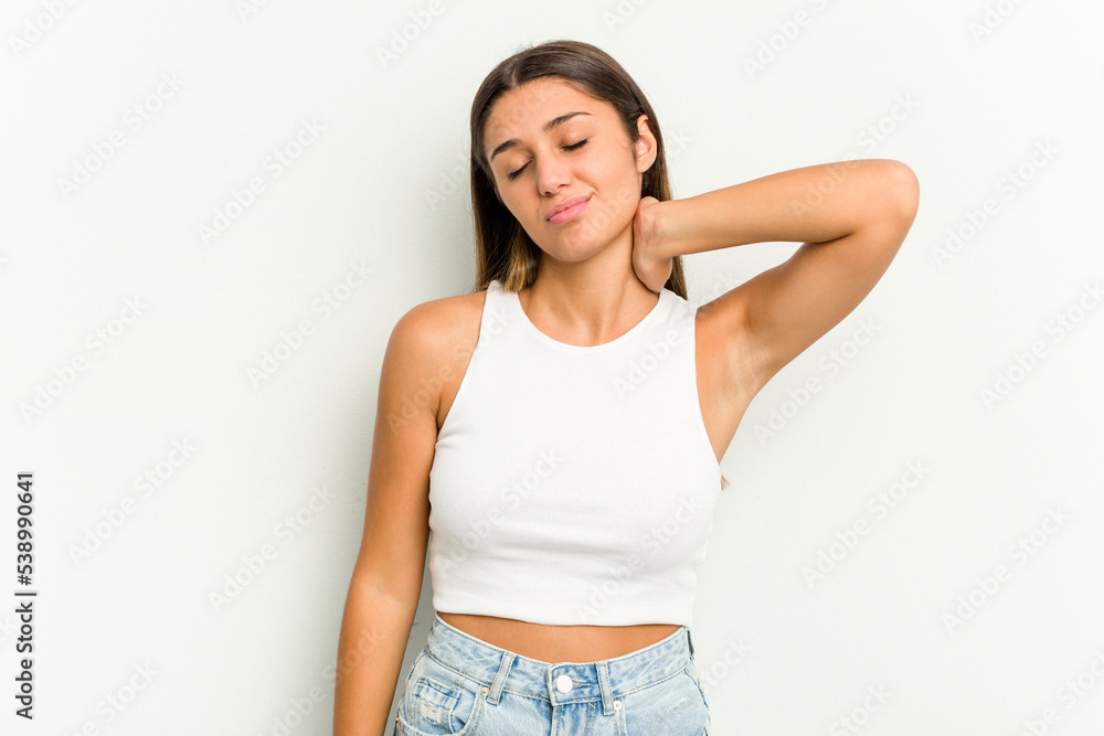 Young Indian woman isolated on white background having a neck pain due to stress, massaging and touching it with hand. Young Indian woman isolated on white background having a neck pain due to stress, massaging and touching it with hand.