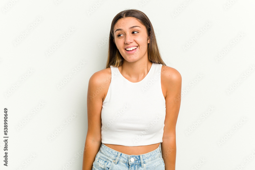 Young Indian woman isolated on white background laughs and closes eyes, feels relaxed and happy. Young Indian woman isolated on white background laughs and closes eyes, feels relaxed and happy.