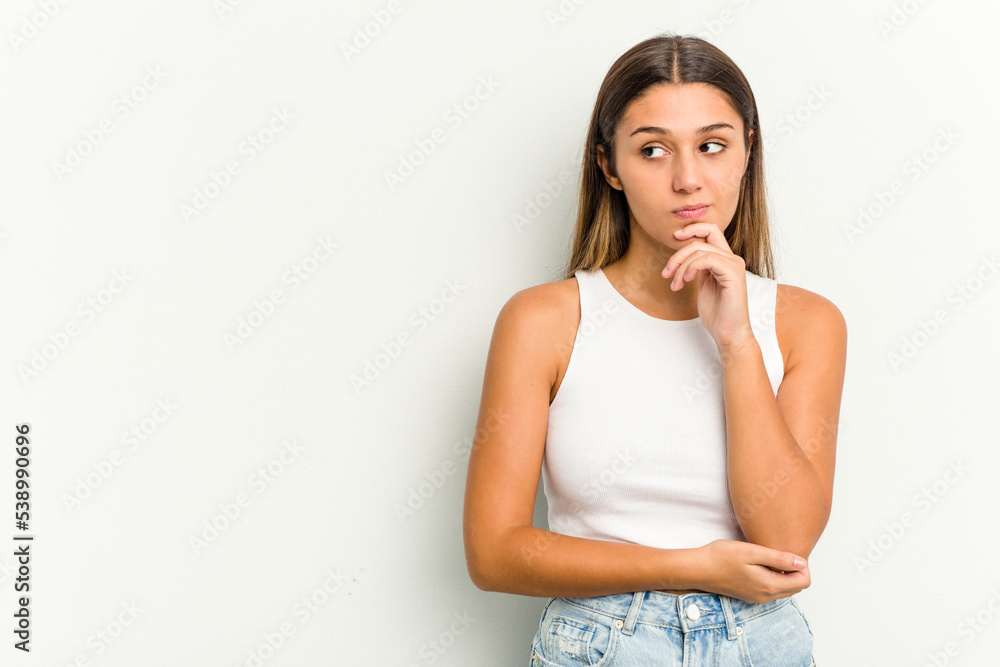 Young Indian woman isolated on white background looking sideways with doubtful and skeptical expression. Young Indian woman isolated on white background looking sideways with doubtful and skeptical expression.