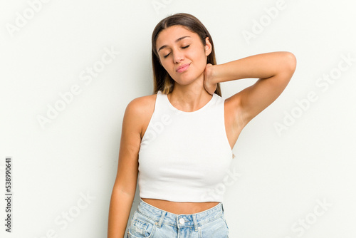 Young Indian woman isolated on white background having a neck pain due to stress, massaging and touching it with hand.
