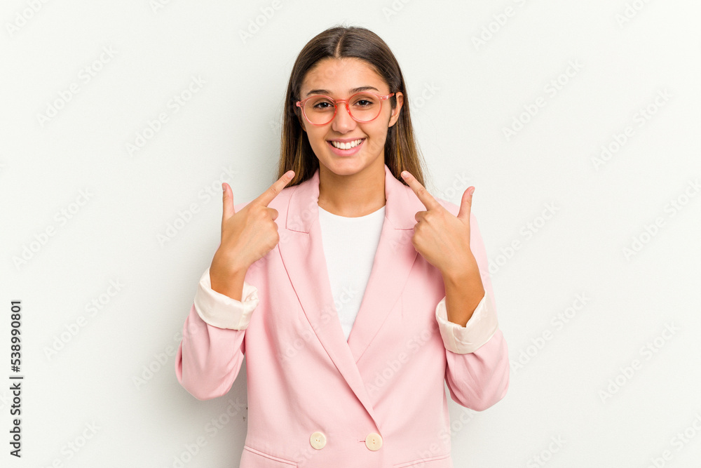 Young Indian woman isolated on white background smiles, pointing fingers at mouth. Young Indian woman isolated on white background smiles, pointing fingers at mouth.