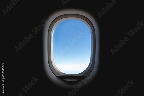 Airplane window with blue sky.