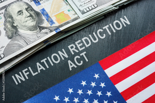 USA flag, dollars and inscription inflation reduction act.