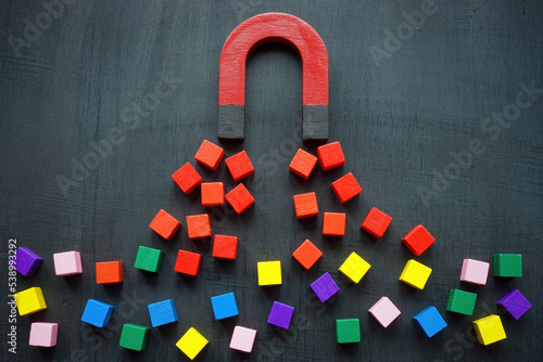 The magnet attracts colored cubes. Leads generation and acquisition concept. photo