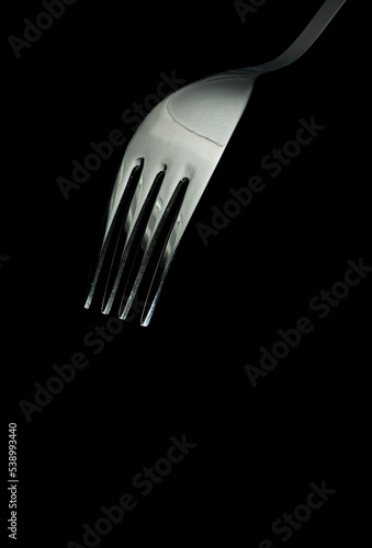 close-up a fork on black background