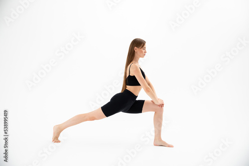 Beautiful girl in sportswear doing yoga