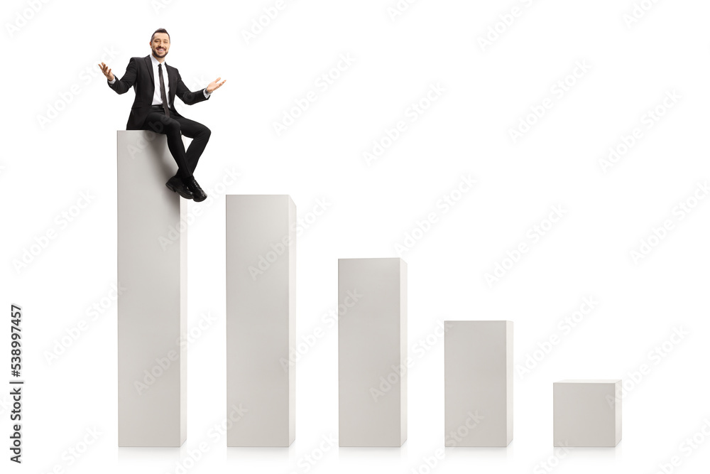 Fototapeta premium Cheerful businessman sitting on a bar chart column and smiling at camera