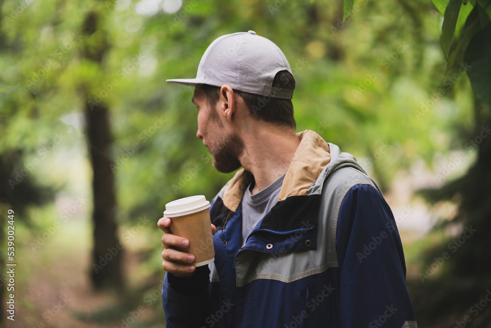 person holding take away paper cup with hot drink person holding take away paper cup with hot drink