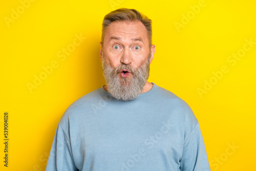 Photo of excited shocked retired guy wear blue sweater big eyes isolated yellow color background