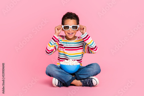 Full size photo of sitting impressed boy wear striped shirt jeans 3d glasses wat Fototapet