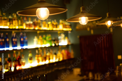 Lamps in the bar. Alcohol is blurred in the background