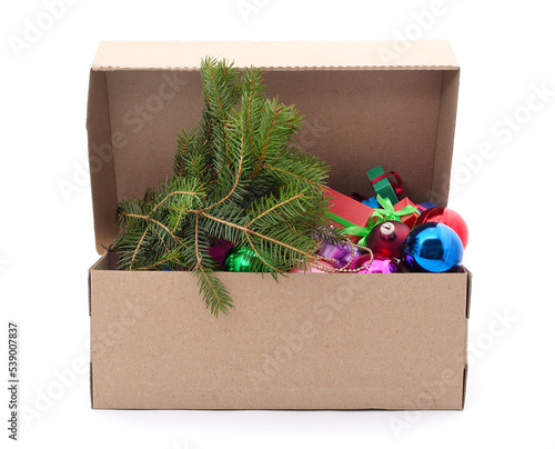 Christmas toys with a Christmas tree branch in a box.