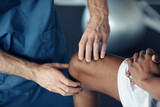 Close-up of doctor examining pain leg of patient during medical exam