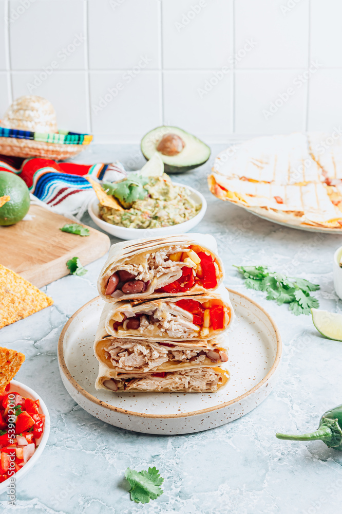 Burritos wraps with mincemeat, beans and vegetables. Mexican dish Burritos wraps with mincemeat, beans and vegetables. Mexican dish