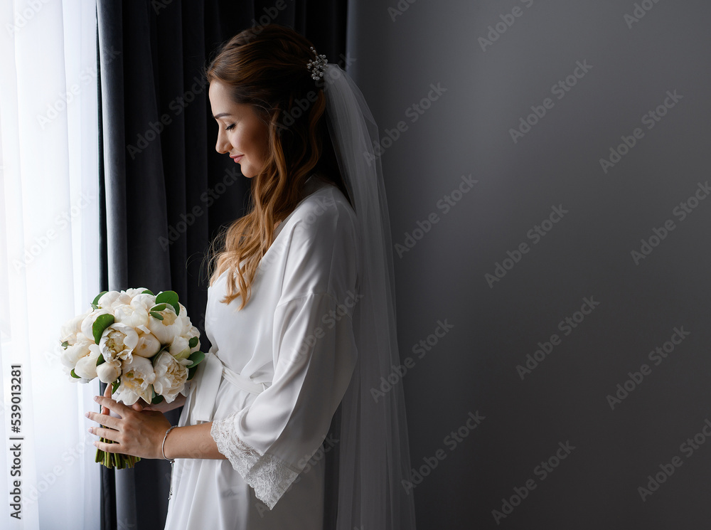 Woman In White Robe With Bouquet Stndsinf Near Window Woman In White Robe With Bouquet Stndsinf Near Window