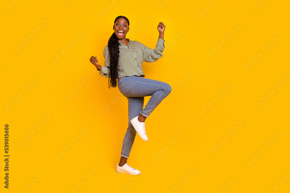 Full size photo of delighted overjoyed person raise fists celebrate luck isolated on yellow color background